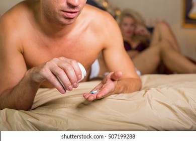 Man taking a pill before sex