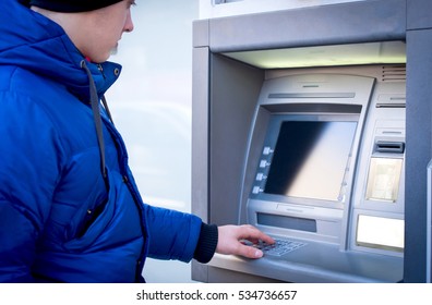 Man taking pin code on ATM