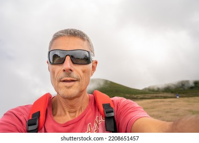 Man Taking Selfie In A Beautiful Mountain Scenario.