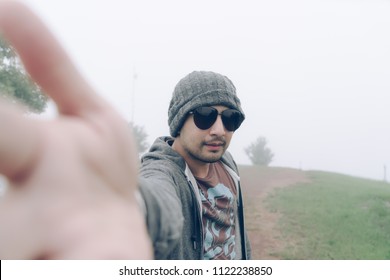 Man Taking Selfie With Foggy On Top Of Mountain. Young Guy Wearing Sun Glasses On Holiday Winter Season. Asian Traveler Take Selfie Nature Outdoor Concept.