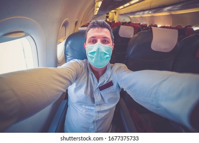 Man Taking Selfie With Mobile Phone On Board Of Plane Wearing Mask
- Man Take Prevention During Coronavirus COVID-19 World Outbreak Concept. Travel Airplan Flight Selfi