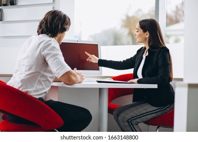 Man Talking With Female Sales Person In A Car Show Room