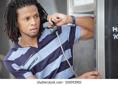 Man Talking On A Payphone