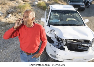 Man Talking On Phone After Car Accident