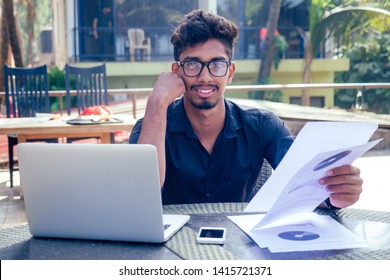 Man Talking On The Phone India Summer Holidays.stylish Young Indian Male Freelancer Working With Laptop Freelance Surfing Online.businessman At Remote Work On The Beach.dream Job.online Purchase Sale