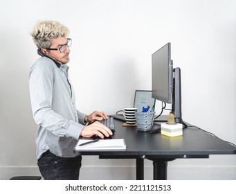 Man Talking On The Phone While Working At The Office In Modern Standing Desk. White Background