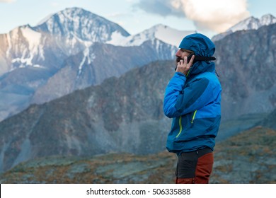 Man Talking On A Satellite Phone In The Mountains