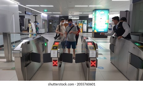 A Man Tap In Card On Jakarta MRT Entrance Gate. Jakarta, 11 October 2021.