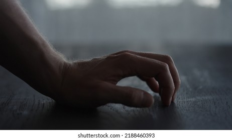 Man Tapping Fingers On Black Oak Table With Back Light, Wide Photo