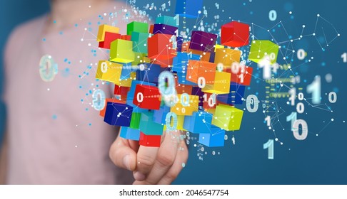 A man tapping on a 3D rendering of colorful cubes and binary code - internet infrastructure concept  Abstract technology background