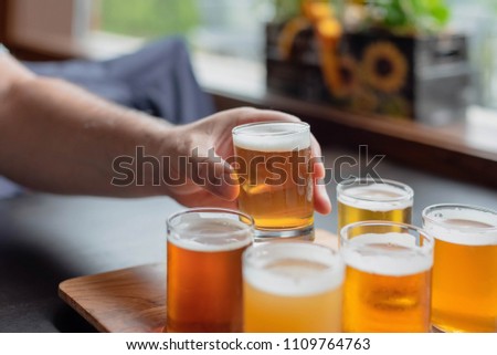 Man tasting beer from flight at a local microbrewery