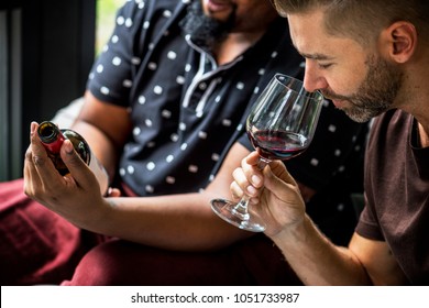 Man Tasting Red Wine With Friends