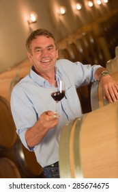 Man Tasting Wine In Cellar, Saint-Emilion, Bordeaux Wineyard, France,