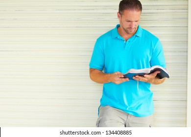 Man With Tattoo Reading The Bible