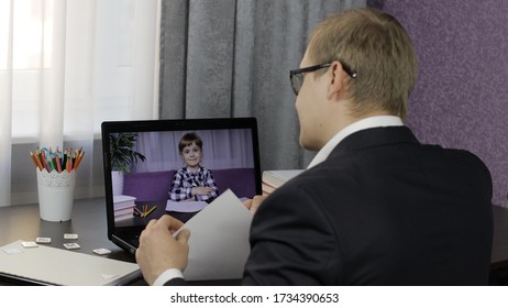 Man teacher making web camera video call doing distant education chat working from home with children online class on laptop computer. Coronavirus quarantine. Communicate with pupil by webcam