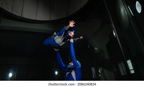 A Man Teaches A Boy To Fly In A Wind Tunnel.