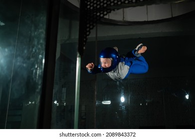 A Man Teaches A Boy To Fly In A Wind Tunnel.