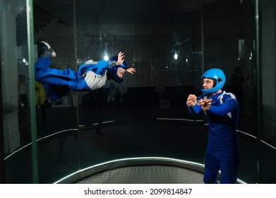 A Man Teaches A Boy To Fly In A Wind Tunnel.