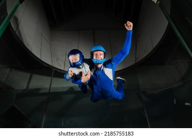 A Man Teaches A Boy To Fly In A Wind Tunnel. Lack Of Gravity.