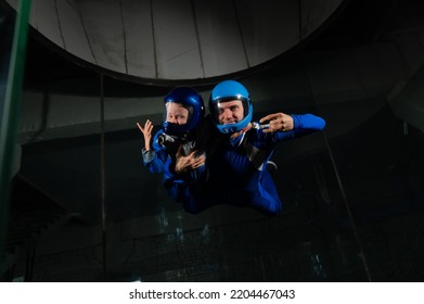 A Man Teaches A Boy To Fly In A Wind Tunnel. Lack Of Gravity.