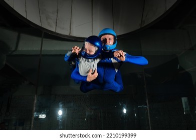 A Man Teaches A Boy To Fly In A Wind Tunnel. Lack Of Gravity.