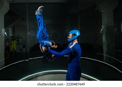 A Man Teaches A Boy To Fly In A Wind Tunnel. Lack Of Gravity.