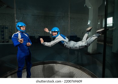 A Man Teaches A Woman How To Fly In A Wind Tunnel. Free Fall Simulator.