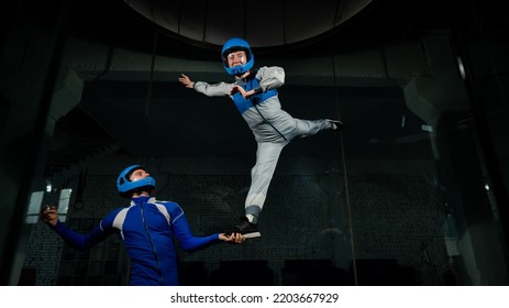 A Man Teaches A Woman How To Fly In A Wind Tunnel. Free Fall Simulator.