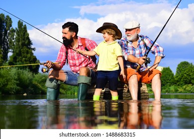 Man Teaching Kids How To Fish In River. Grandfather, Father And Boy Fishing Together. Dad And Son Fishing At Lake. Summer Weekend