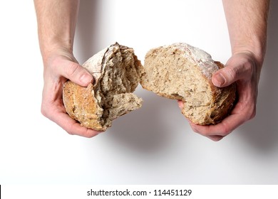 Man Tearing Bread In Half