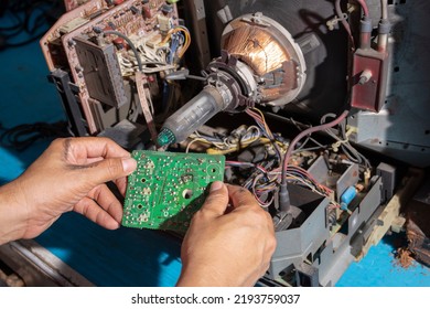 A Man Technician Repairing A Television. Repairman Are Checking Television Circuit Board. TV Repair Service Center Concept