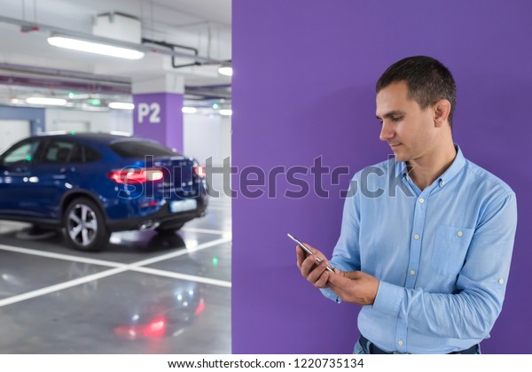 Man with a\
telephone on the underground\
parking