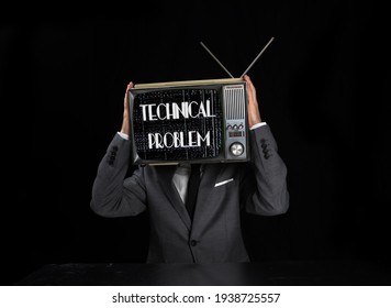 Man with television stuck on head with the words technical problem on the screen