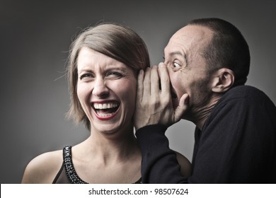 Man Telling A Laughing Woman A Joke