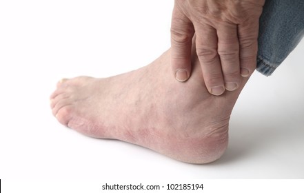 A Man Tends To His Sore Ankle