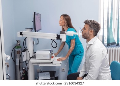 Man testing breathing function by spirometry. Diagnosis of respiratory function in pulmonary disease