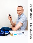 Man testing glucose level with a digital glucometer, sensor checkup glucose levels without blood. Diabetes treatment.