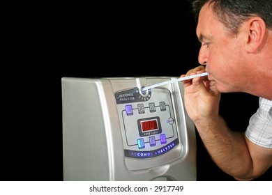 Man Tests His Alcohol Level With A Breath Test Machine.