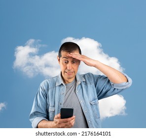 Man texting using smartphone over isolated cloud background stressed with hand on head, shocked with shame and surprise face, angry and frustrated. Fear and upset for mistake.Online cloud communicatio