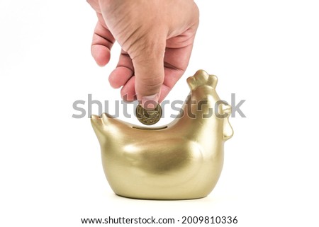 A man with a Thai coin carrying to chicken bank isolated on white background, saving money wealth and financial concept