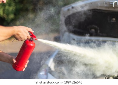 A Man That Use A Fire Extinguisher To Turn Off The Fire From The Car Engine  