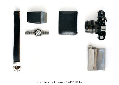 Man things flat lay on white background. Composition with camera, watch, flask, purse, belt, and razor with place for art work.