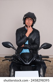 A man thinking about something while sitting on the motorcycle