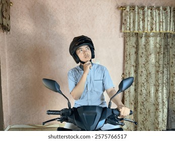 A man thinking about something while sitting on the motorcycle