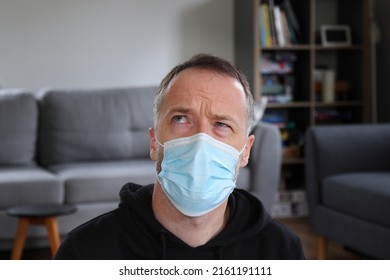 Man Thinking. Concentrated Person Doing Heavy Thinking In Face Mask. Bearded Man Wearing Casual Black Hoodie. Adult Caucasian Man In 30s Or 40s.