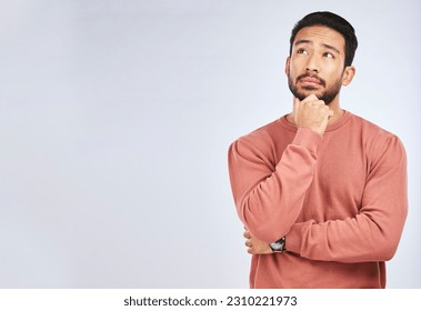 Man, thinking and idea mockup in studio or planning, decision and choice with white background. Asian male, model and curious face with doubt, questions or confused guy try to remember with space