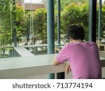 Man  thinking seriously while sitting coffee shop.