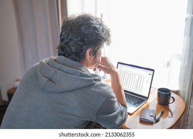A man thinking while looking at a computer