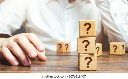 Man Is In Thought And Blocks With Questions. Pondering The Problem, Gathering All The Facts. Make The Right Decision. Reasoning, Weighing Results And Consequences. Reflection And Planning. Strategy.