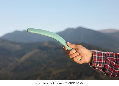 Man Throwing Boomerang In Mountains, Closeup View